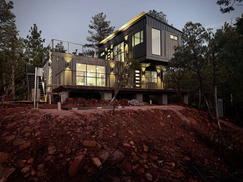 Aerial view of a remote cabin surrounded by dense forest